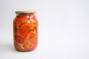 Glass jar of canned products: various vegetables, peppers, onions, carrots, tomatoes. Lecho, vegetable salad. Isolate on white background