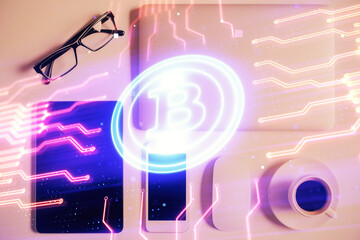 Double exposure of blockchain theme hologram over table with phone. Top view. Crypto technology concept.