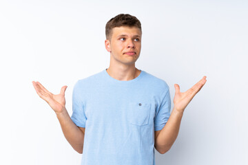 Young handsome man over isolated white background making doubts gesture