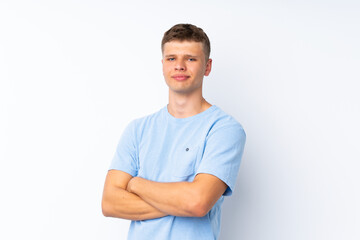 Fototapeta premium Young handsome man over isolated white background with arms crossed and looking forward