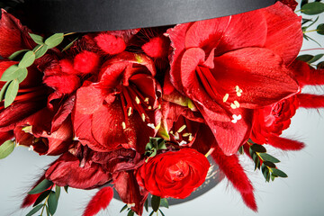 top view on beautiful bouquet made from red lilies, roses, and fresh greenery