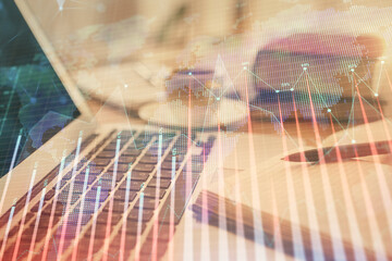 Double exposure of financial chart drawing and desktop with coffee and items on table background. Concept of forex market trading