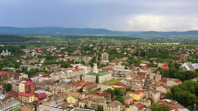 Birds eye view of old European city Drohobych. Central point of the city with beautiful city hall at square and architecture around. 4K Aerial drone view