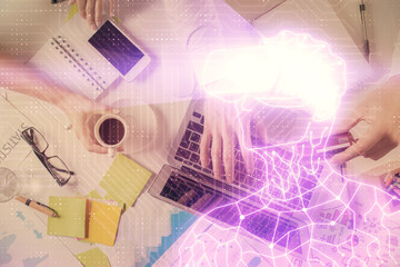 Double exposure of man's hands typing over computer keyboard and virtual reality hologram drawing. Top view. Technology concept. Future.