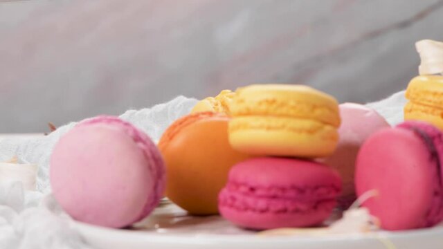 A french sweet delicacy, macaroons variety closeup. Color fresh macaroons on wooden background.