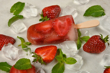 Strawberry ice cream popsicle on table