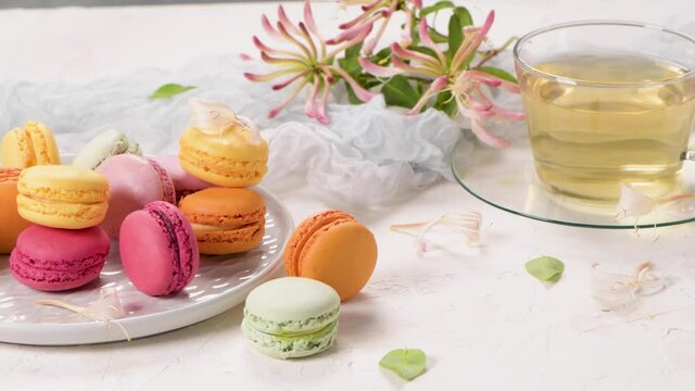 A french sweet delicacy, macaroons variety closeup. Color fresh macaroons on wooden background.