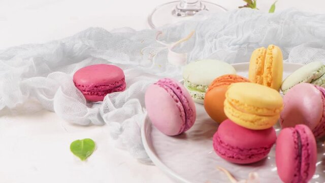 A french sweet delicacy, macaroons variety closeup. Color fresh macaroons on wooden background.