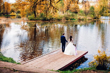 
bride and groom in autumn park
