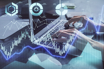 Double exposure of woman hands typing on computer and forex chart hologram drawing. Stock market invest concept.