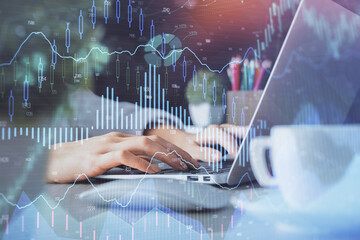 Double exposure of woman hands typing on computer and forex chart hologram drawing. Stock market invest concept.