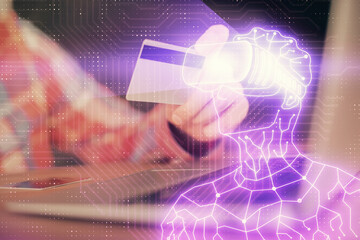 Double exposure of man hands holding a credit card and human in vr glasses drawing. Virtual reality and E-commerce concept.