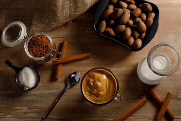 Dalgona coffee - the Korean coffee drink on wooden background. Instant coffee or espresso powder whipped with sugar and hot water. Iced whipped dalgona coffee concept.top view.
