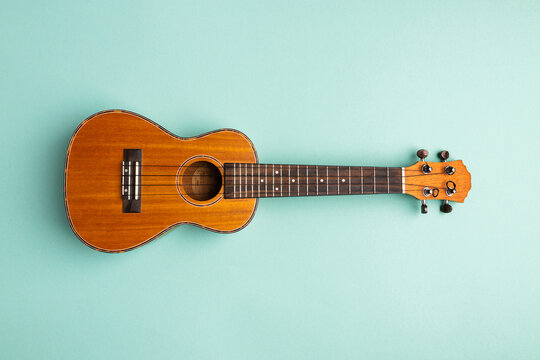 Ukulele isolated on abstract blue background with copy space