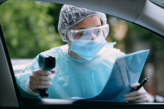 Doctor woman use infrared thermometer gun to check body temperature