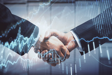 Double exposure of forex graph hologram and handshake of two men. Stock market concept.
