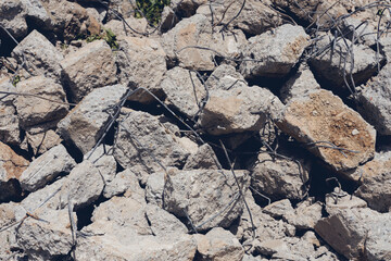 The rebar sticking up from piles of brick rubble, stone and concrete rubble. Remains of the destroyed industrial building.