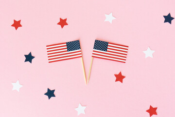 Two american flag toothpick and star on pink background, flat lay. 4th of july, usa independence...