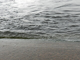 Saint-Petersburg.In a city on the banks of the Neva river.Its waters flow along granite embankments.