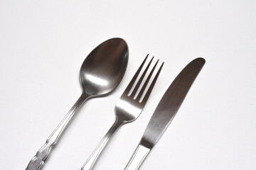 cutlery set of silver spoon, fork and knife isolated on a white backround