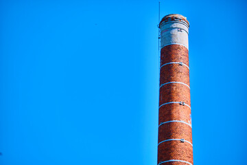brick pipe against the blue sky. general plan color