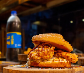 American style burger sandwich consisting of fried chicken and slices of cheese with distinctive...