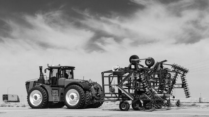 Black & White tractor and harvester on the Colorado prairie.