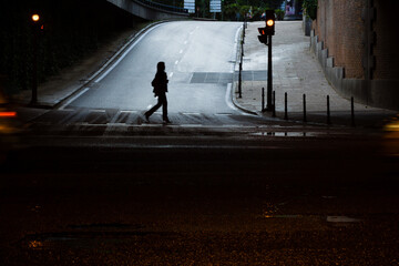 Una persona cruzando la calle, en un paso de peatones.