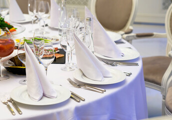 Table set for a celebration and reception, table setting at a banquet in a restaurant