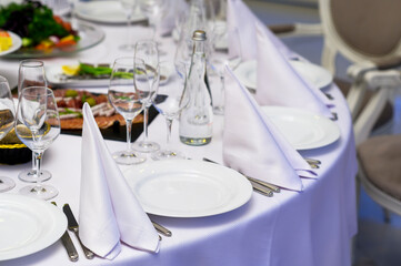 Table set for a celebration and reception, table setting at a banquet in a restaurant