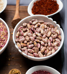 Beans in a white bowl on a wooden board