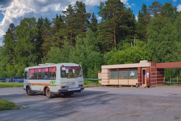 A bus awaits passengers at a stop in a small town.