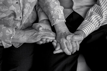 Older people holding hands close-up. Wrinkled hands of elderly people.