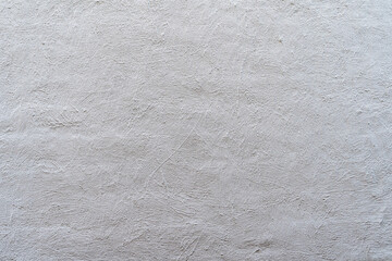 decoratively plastered wall painted with light paint background