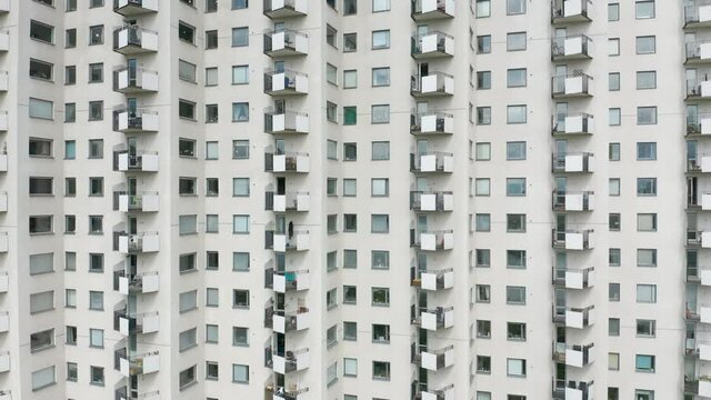 Exterior of a white high rise residentail apartment building & windows