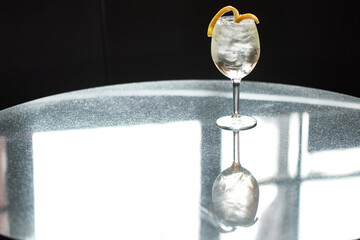 Cocktail with Lemon Twist Garnish on Reflective Table
