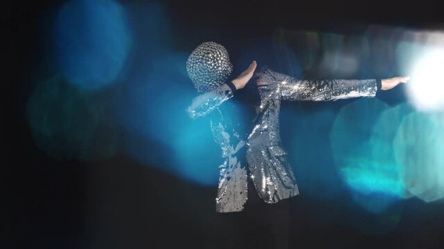 Mr disco ball wearing silver jacket doing the dab