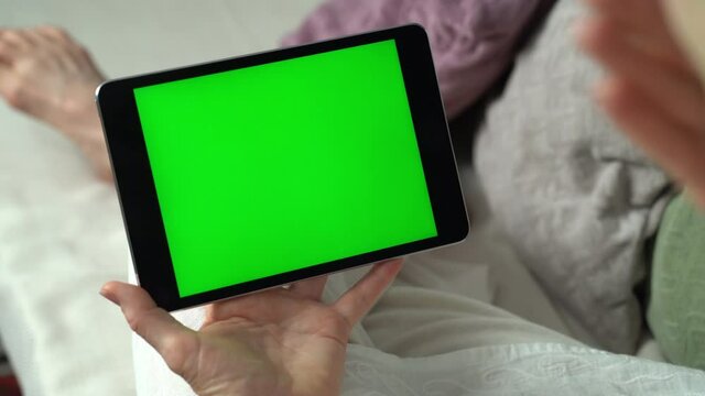 Closeup of green screen video call via tablet talking to someone. Friends, facetime, online, internet, long distance communication, chatting concept. skype chatting with grandmother.