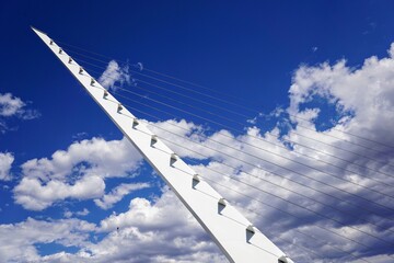 Fototapeta premium Modern designed suspension bridge with clouds in the background 