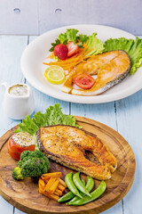 Salmon steak on wooden plate