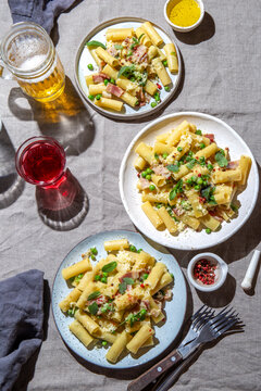 Rigatoni pasta with green pea, mint leaves, smoked bacon and cheese