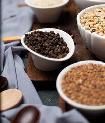 Black beans and buckwheat in a white bowl on a wooden board