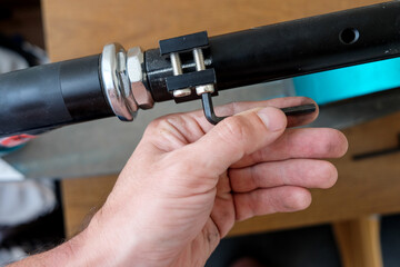 loosening the screw with a hex wrench. repair of household items at home