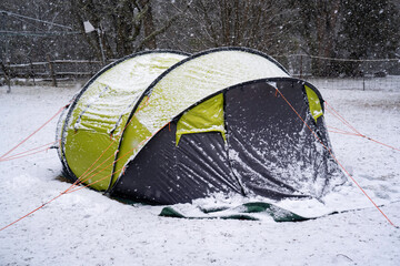 Green and black tent covered in snow in outback Australia  © Em Neems Photography