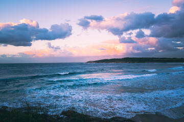 sunset over the sea, sun is purple and pink, epic sunset