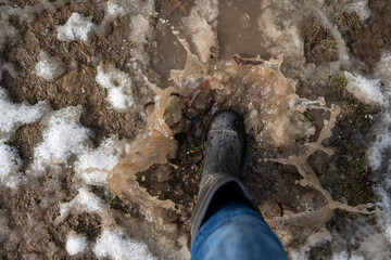 boot in snow, jumping into a big puddle of melted snow