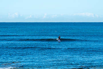 Active male man in ref kayak at the beach/ catching waves in canoe