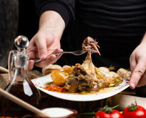 delicious meat meal with tomato on dark background