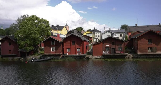 4K video of Porvoo vintage red wooden buildings, Porvoo Cathedral, yachts and boats in Porvoonjoki River near town center on sunny summer day in Finland, northern Europe