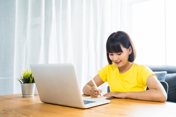 Online class learning student studying lockdown quarantine homeschooling and distance learning education, Asian beautiful girl living room study at home using computer laptop video call communication